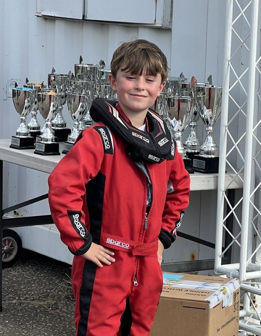 Oliver in front of the Project One trophies